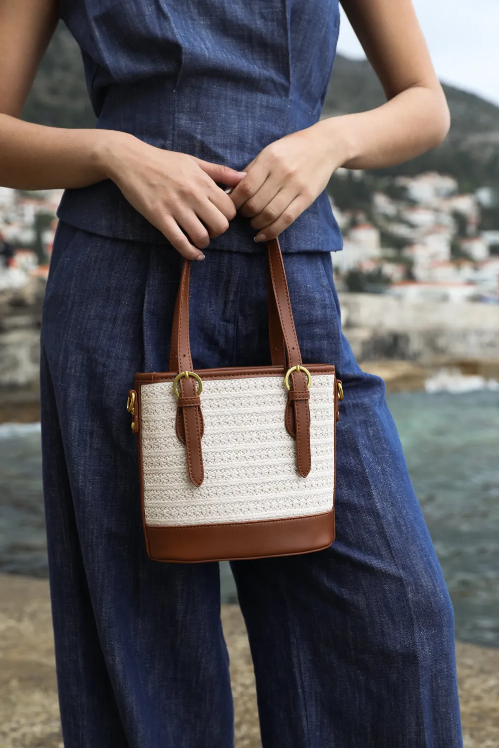 ENCANTO SMALL RAFFIA BAG WITH BUCKLE DETAIL AND CROSS BODY STRAP IN TAN