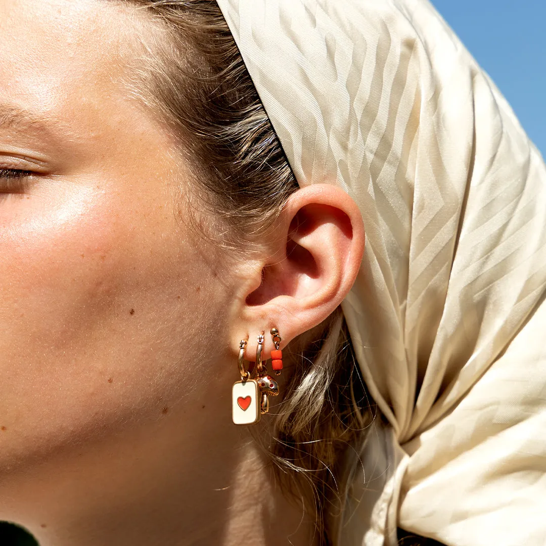 Rose gold coloured/red hoop earring with a heart plate